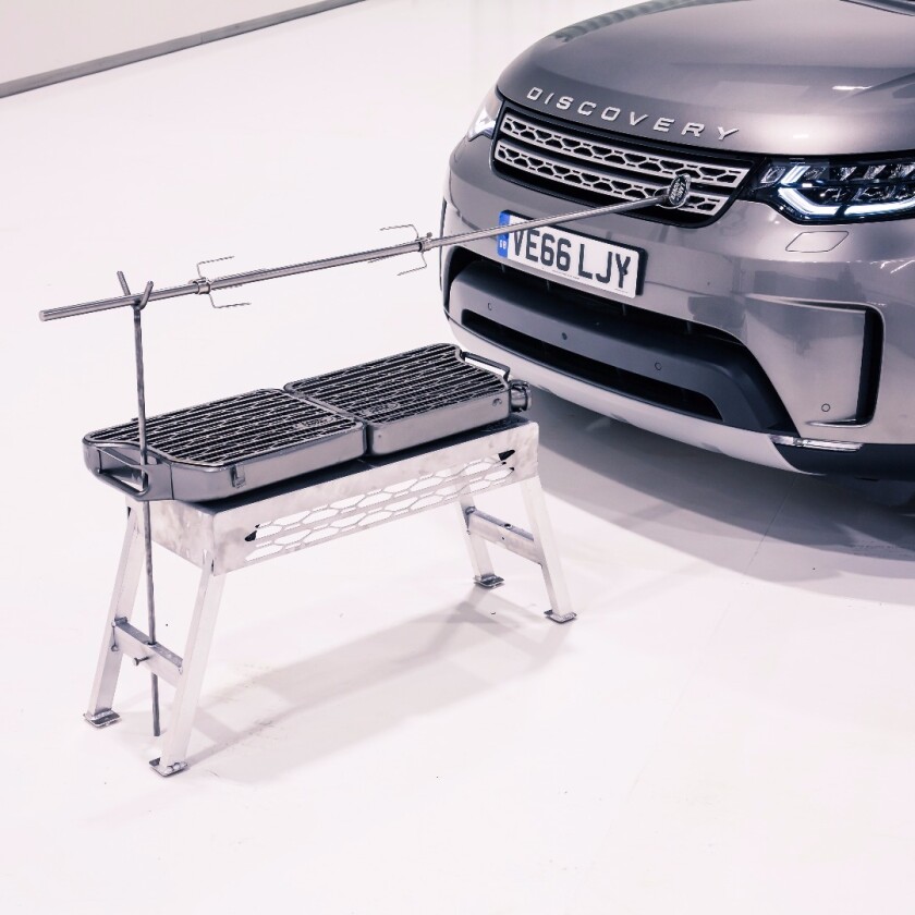 The build includes a standalone, folding charcoal/wood grill built from a jerry can with a Land Rover grille-inspired cooking surface