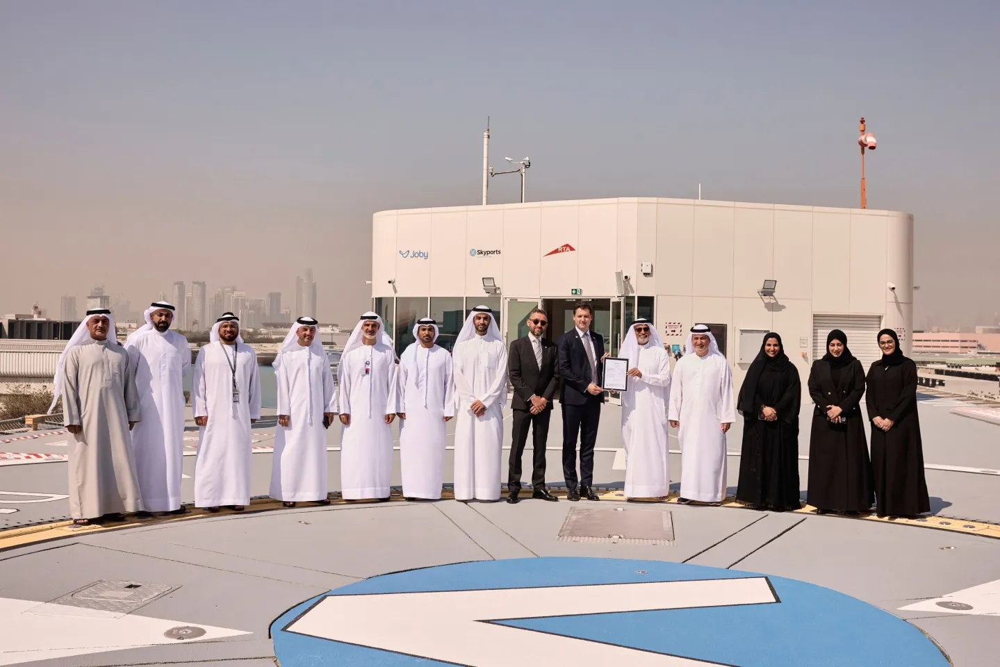 Skyports officials receive a certificate of regulatory approval on the roof of the VDX vertiport