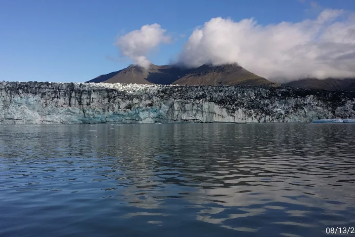 About 11 percent of Iceland is covered in glaciers with a full eight percent coming from the Vatnajökull glacier in the southeast of the country. With an area of 8,300 sq km (3205 sq mi), it has the same mass as all of the glaciers on mainland Europe put together. This shot was taken at the Jökulsárlón glacial lagoon, a spot where the massive glacier has an outlet, or an area where the giant ice lake flows outwards. This wall is the site of regular calving, where chunks of ice drop into the lagoon to become icebergs.