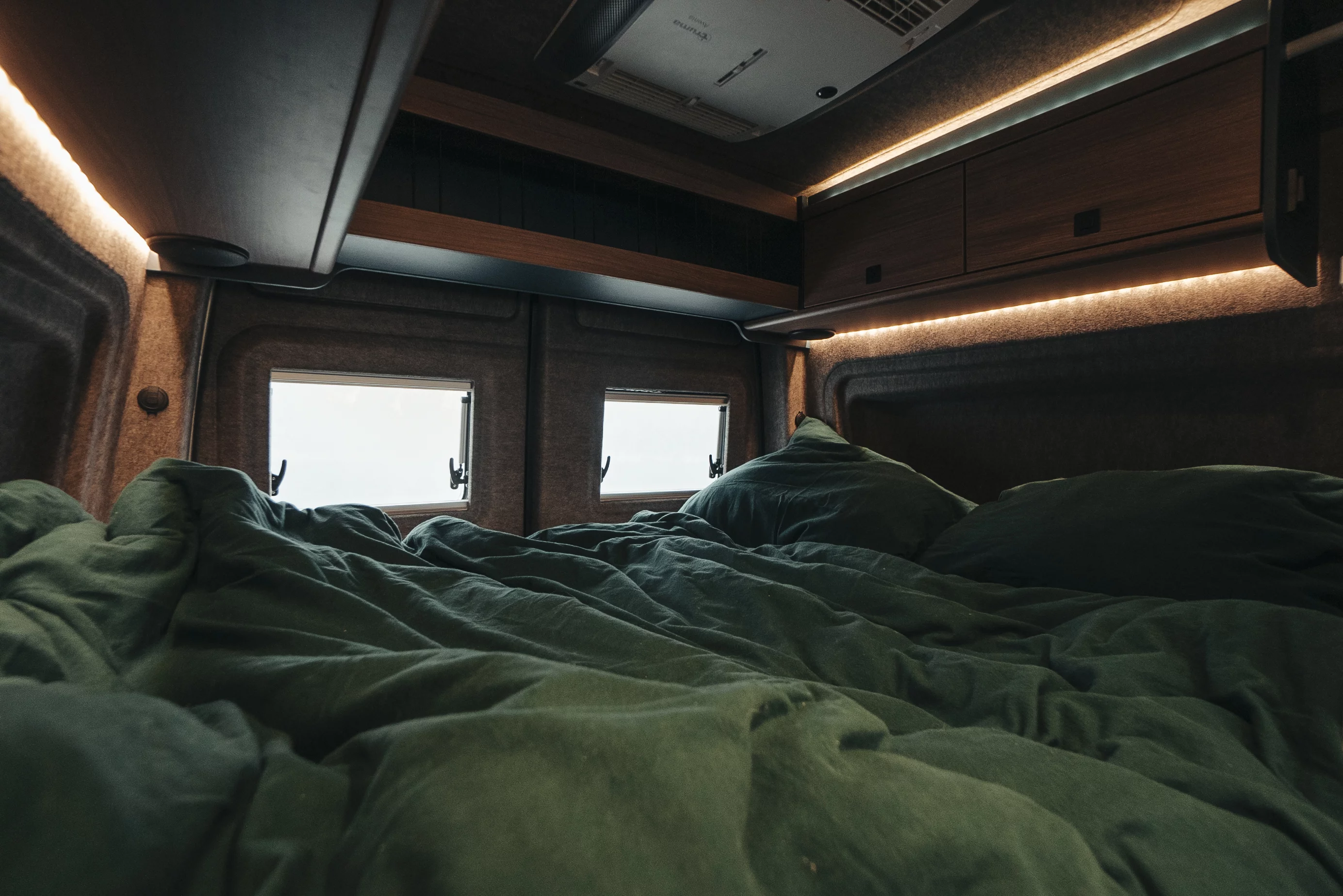 The primary rear bed sleeps two, and an available convertible front bed kit adds a third berth