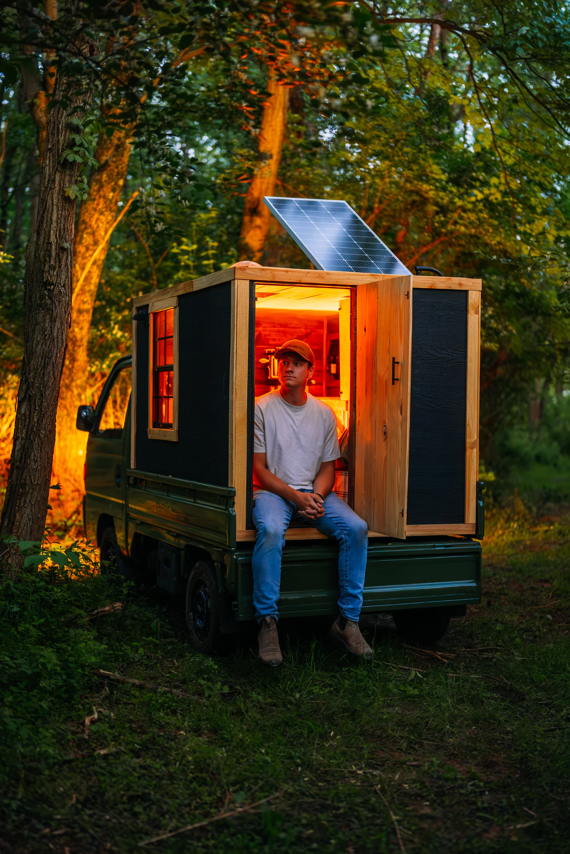 The micro-camper shell was built from wood and features a door for access plus some windows