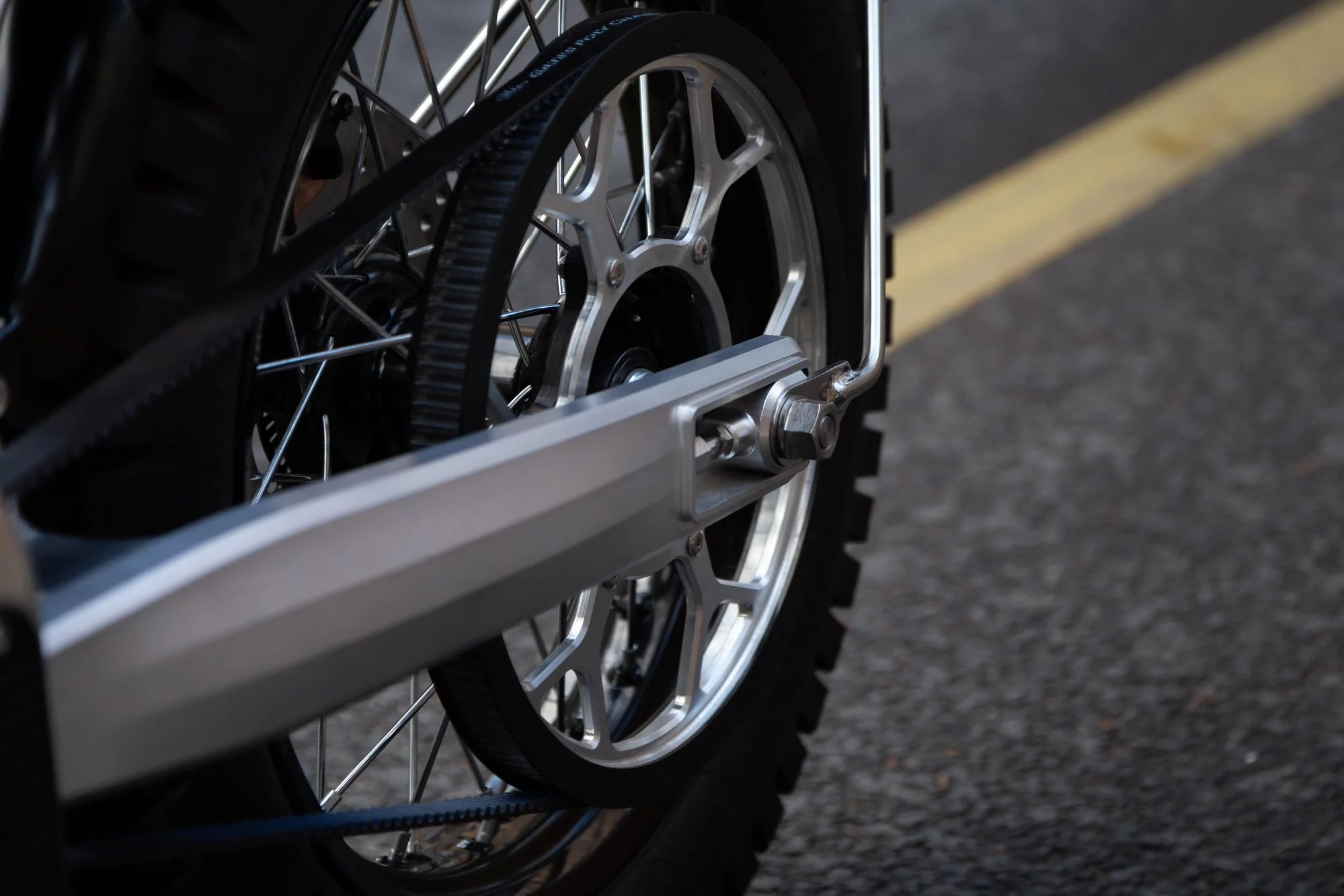 6061 aluminum swingarm and close up of the eScrambler's rear wheel sprocket