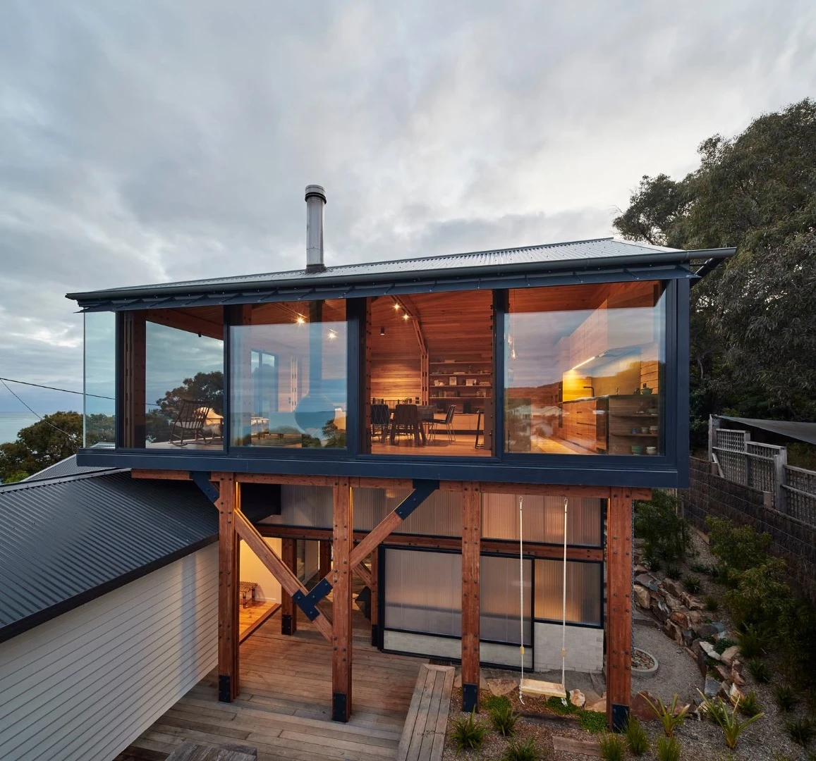 Austin Maynard Architects crafted a timber box partly over the old shack but leaving the older home untouched