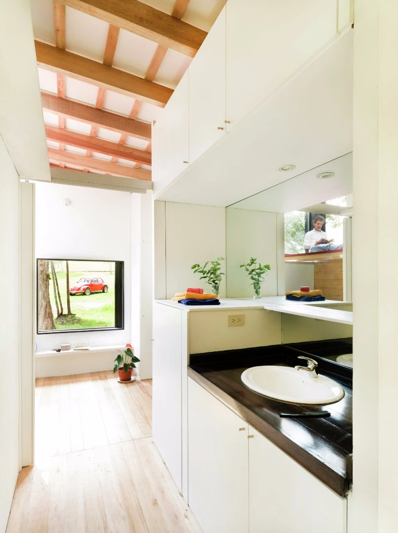 A fully-equipped bathroom is located in the center of the home