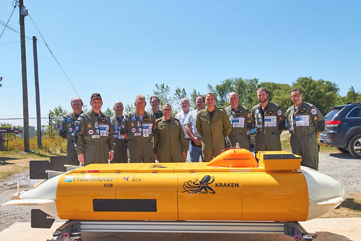 The "Raise the Arrow" team gathers for a photo behind the AUV