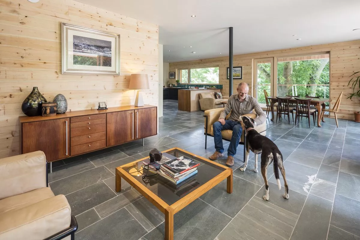 Dursely Treehouse features floor-to-ceiling glass windows, large open plan living and beautiful slate flooring