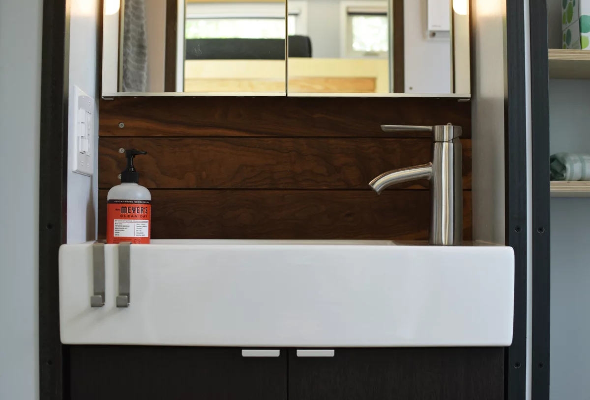 The bathroom includes a shower, sink, and composting toilet