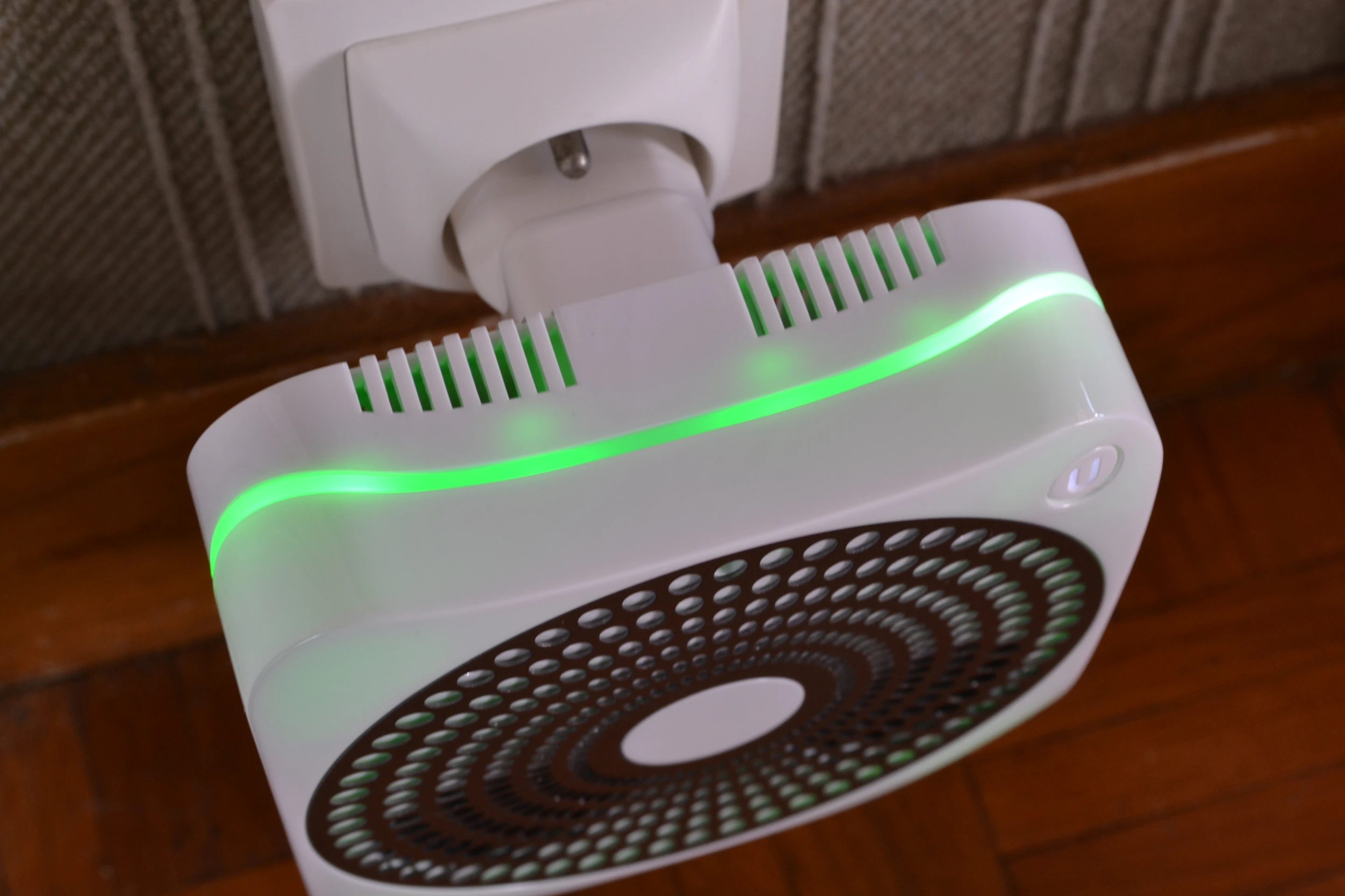 The device is edged by a wavy multi-colored LED light band sandwiched between the front and back of the casing