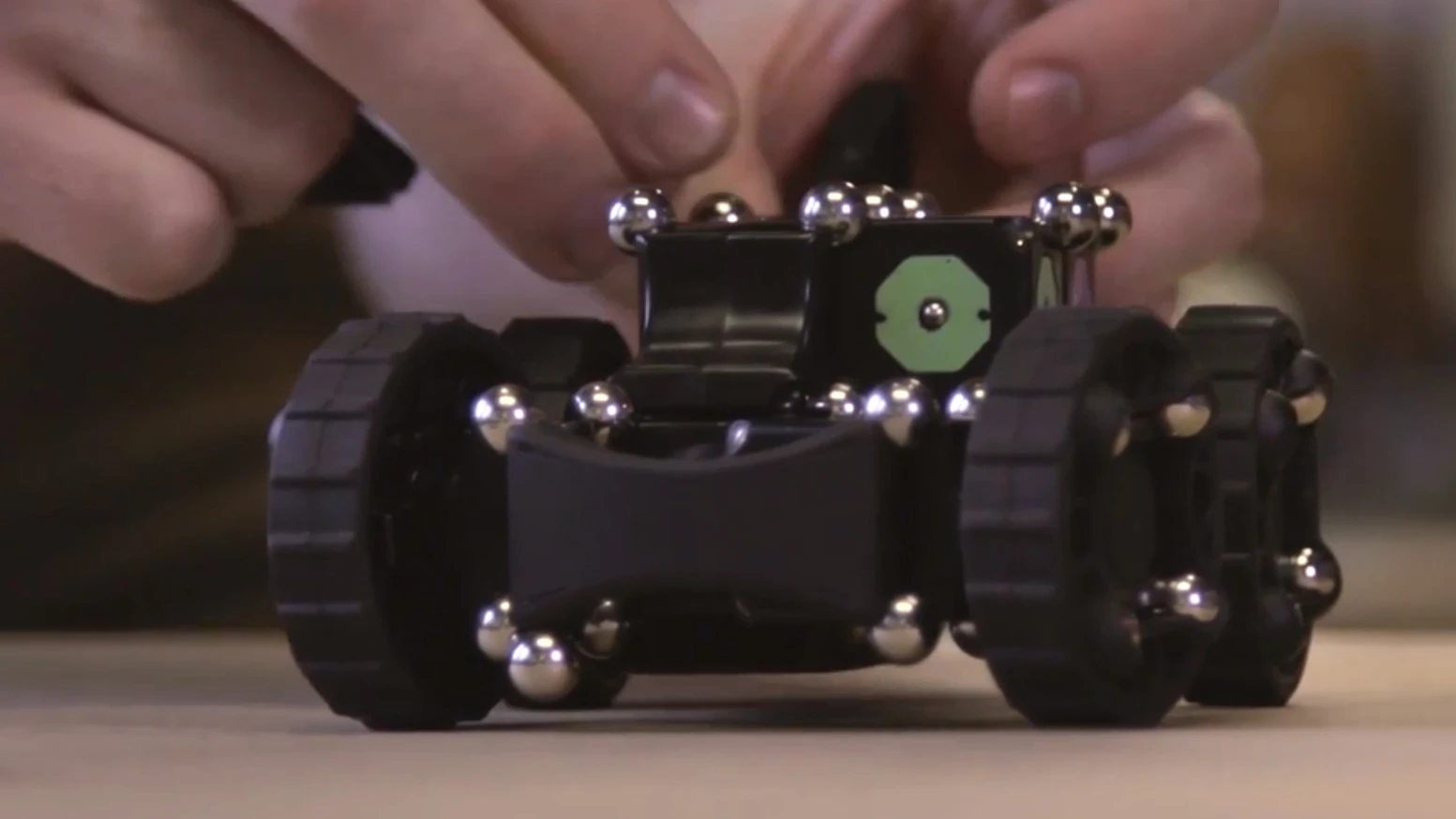 A carbon steel ball bearing/neodymium rare earth magnet connection system provides plenty of flexibility