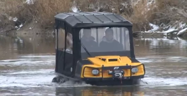 An ARGO XTI with available canopy shows off its water skills