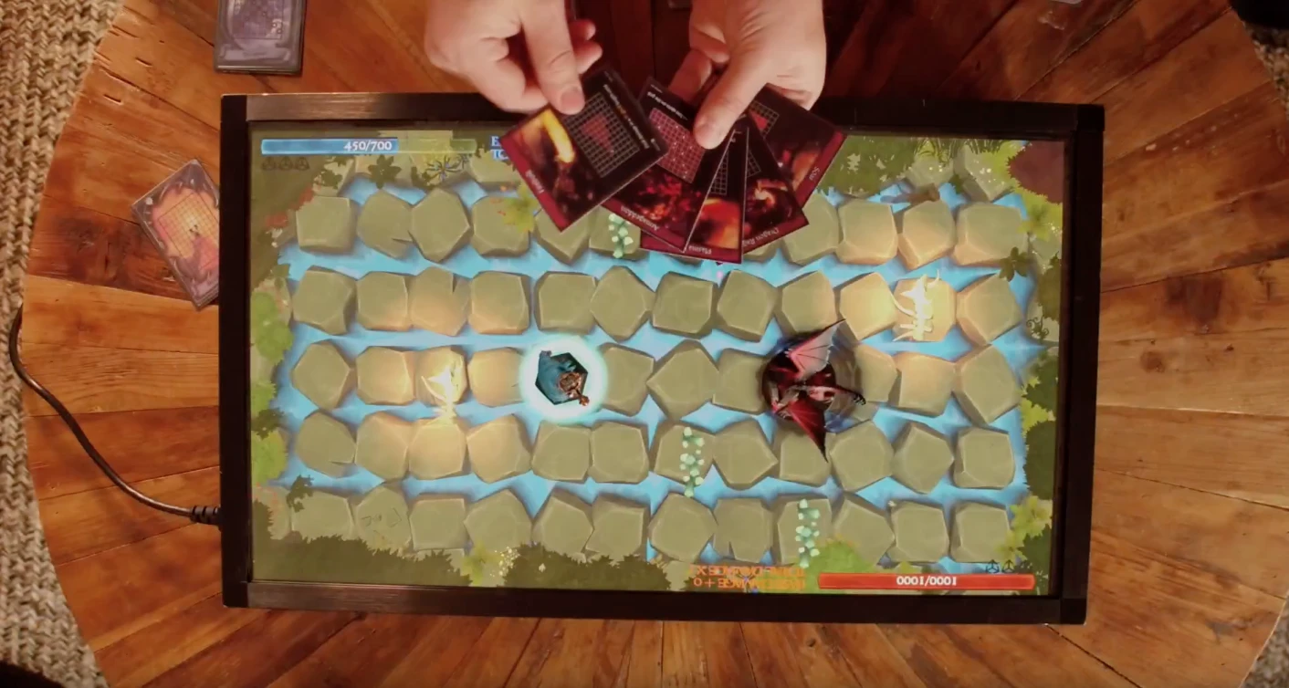 PlayTable is a gaming console that can be played using physical game pieces, or users' mobile phones