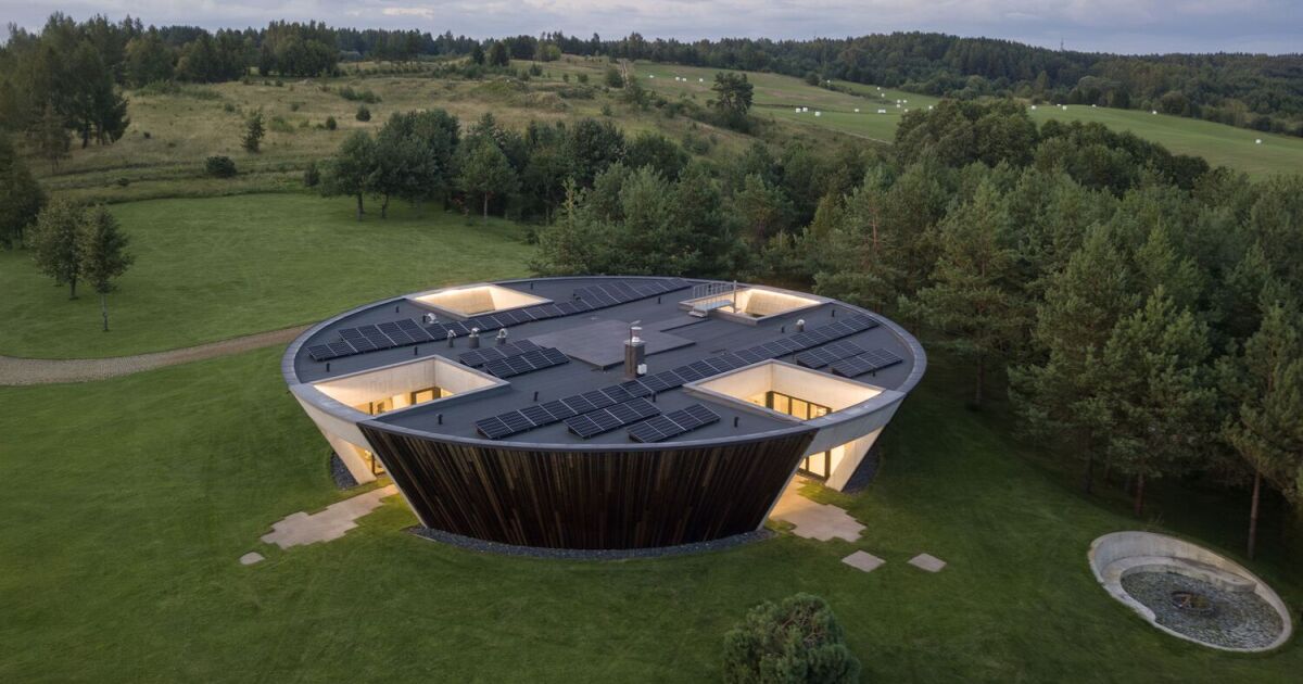 Circular home features four sunken courtyards in Lithuania