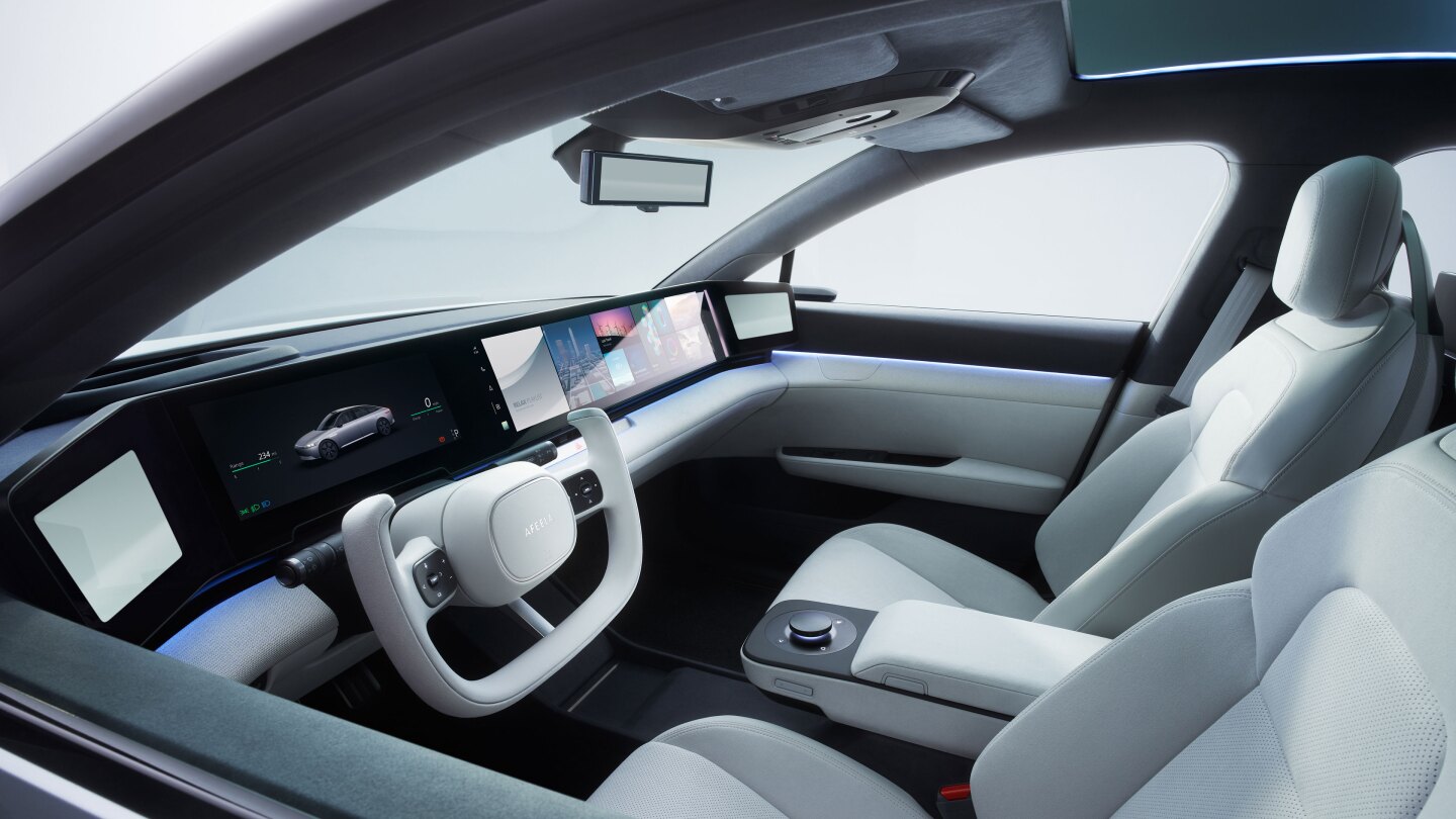 Like the original Vision-S concept, the Afeela prototype has a full-width digital dashboard covered by a side-view camera screen.