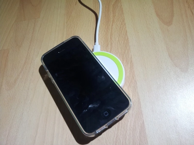 The iPhone is then placed, patch-down on the charging pad to charge
