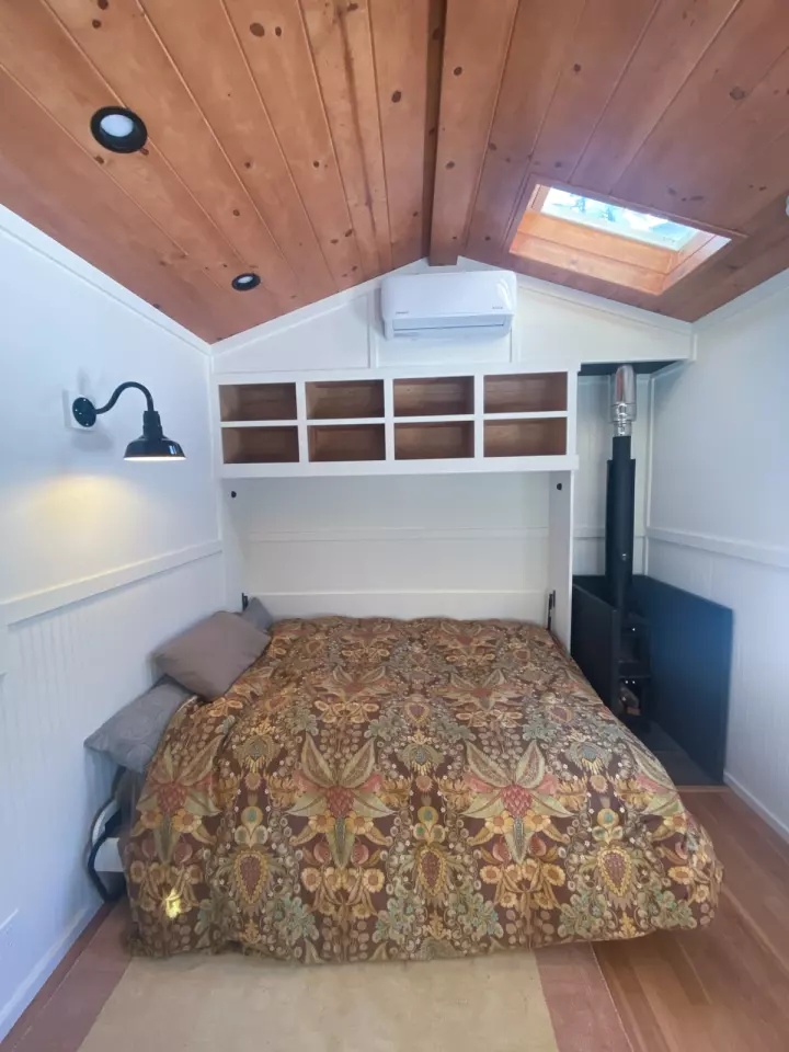 The Off-Grid Luxury Mobile Double Office's larger workspace includes a Murphy style double bed that folds away when not in use