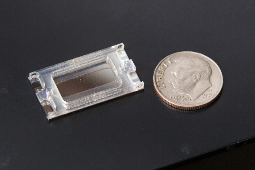 Nanoparticle removal chip next to a dime for comparison