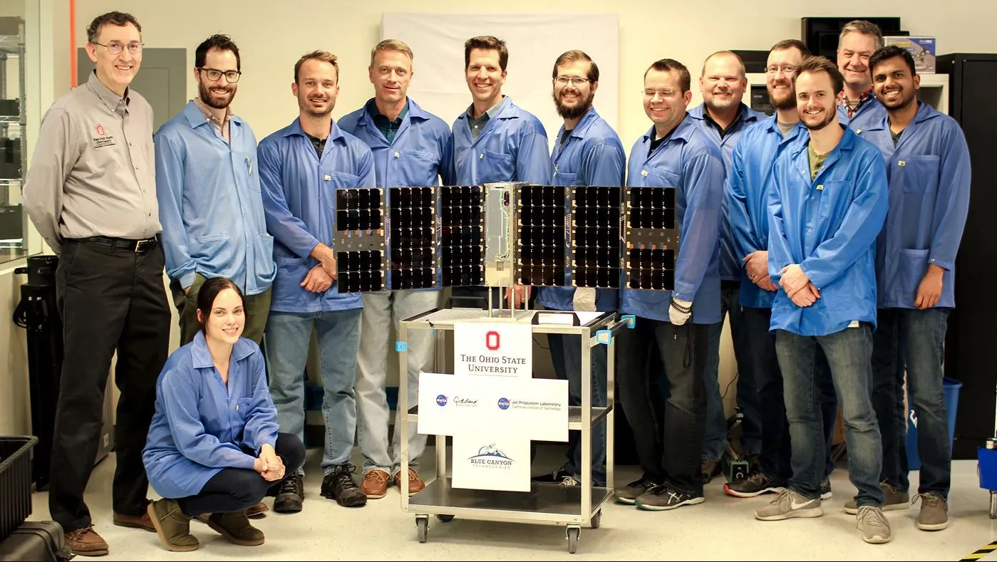 The CubeRRT satellite and Blue Canyon Technologies team members with Principal Investigator Joel Johnson (far left) of The Ohio State University