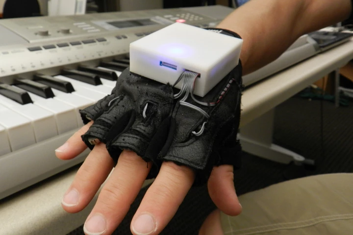 The Mobile Music Touch (MMT) system comprises a vibrating glove that connects wirelessly to a computer, MP3 player or smartphone