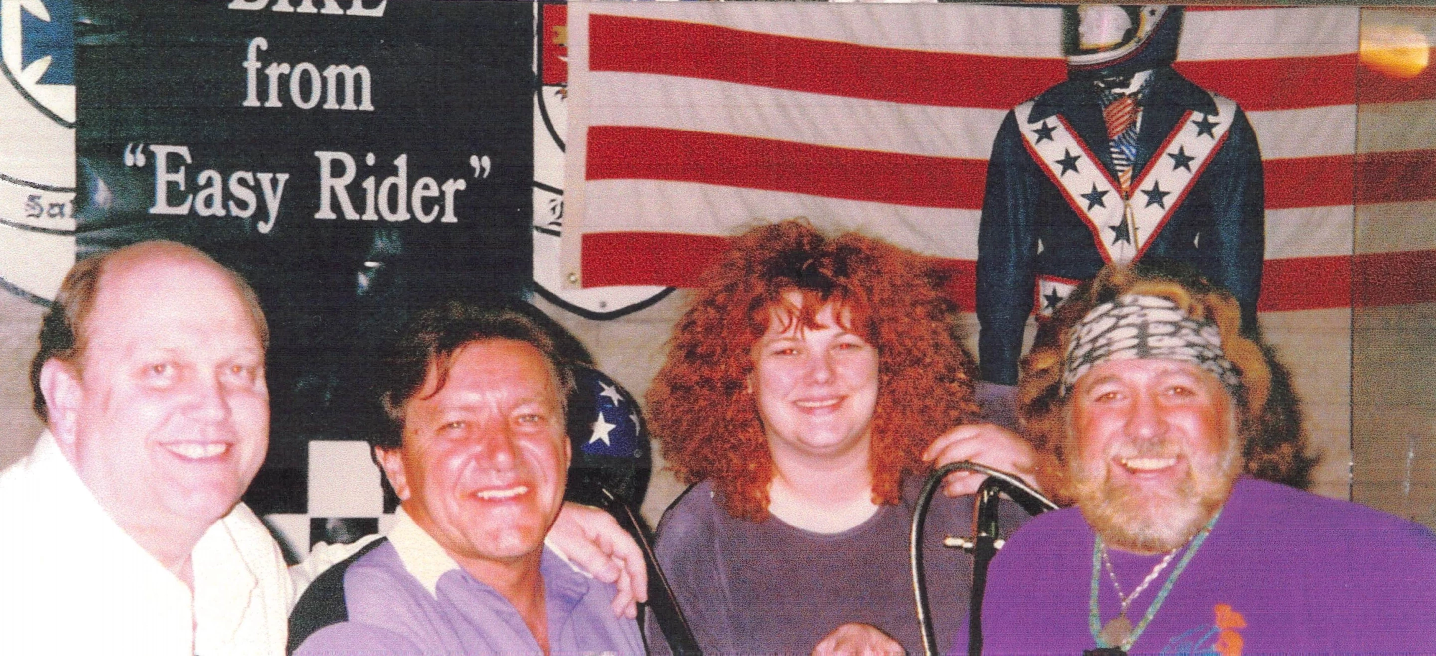 This image was taken at the 1996 auction of the Captain America Harley-Davidson Panhead Chopper by Dan Kruse Classics when the machine was sold by Gary Graham, being purchased by Gordon Granger. From left to right: Dan Kruse, Gary Graham, Tiffany Kruse and Dan Haggerty.