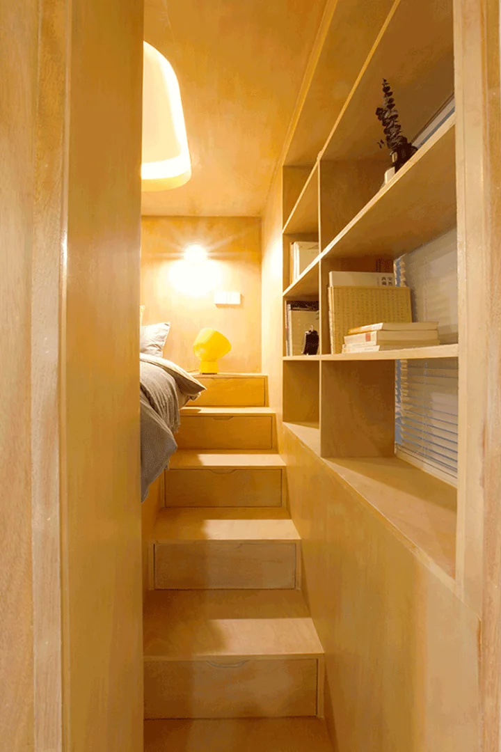 Hidden storage is included beneath both sets of stairs which sit on either side of the elevated queen bed