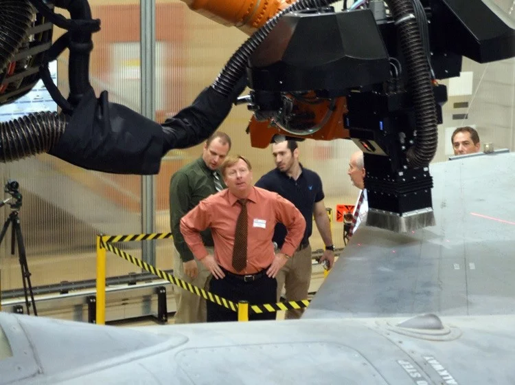 Sensors allow the arm to glide evenly over the plane’s surface