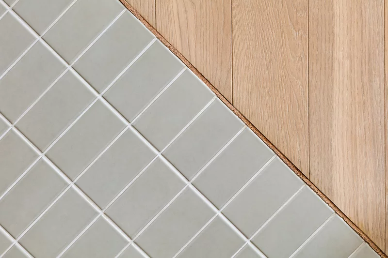 Cool gray tiling and warm timber floors work well together in the home