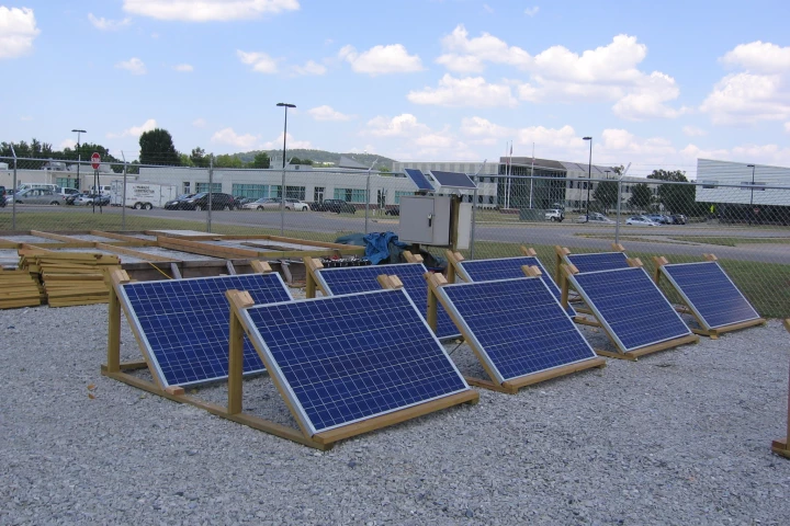 The photovoltaic panels and concrete panels (background) being used in the experimental solar-powered runway de-icing system