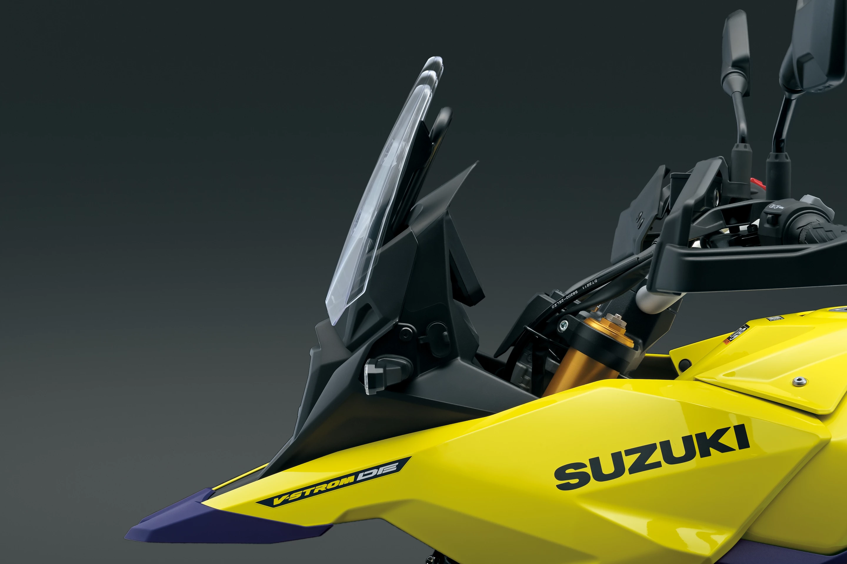 The tiny screen of the 2023 Suzuki V-Strom 800DE can be adjusted in three positions, but the process requires tools to reposition the four screws that secure it in place