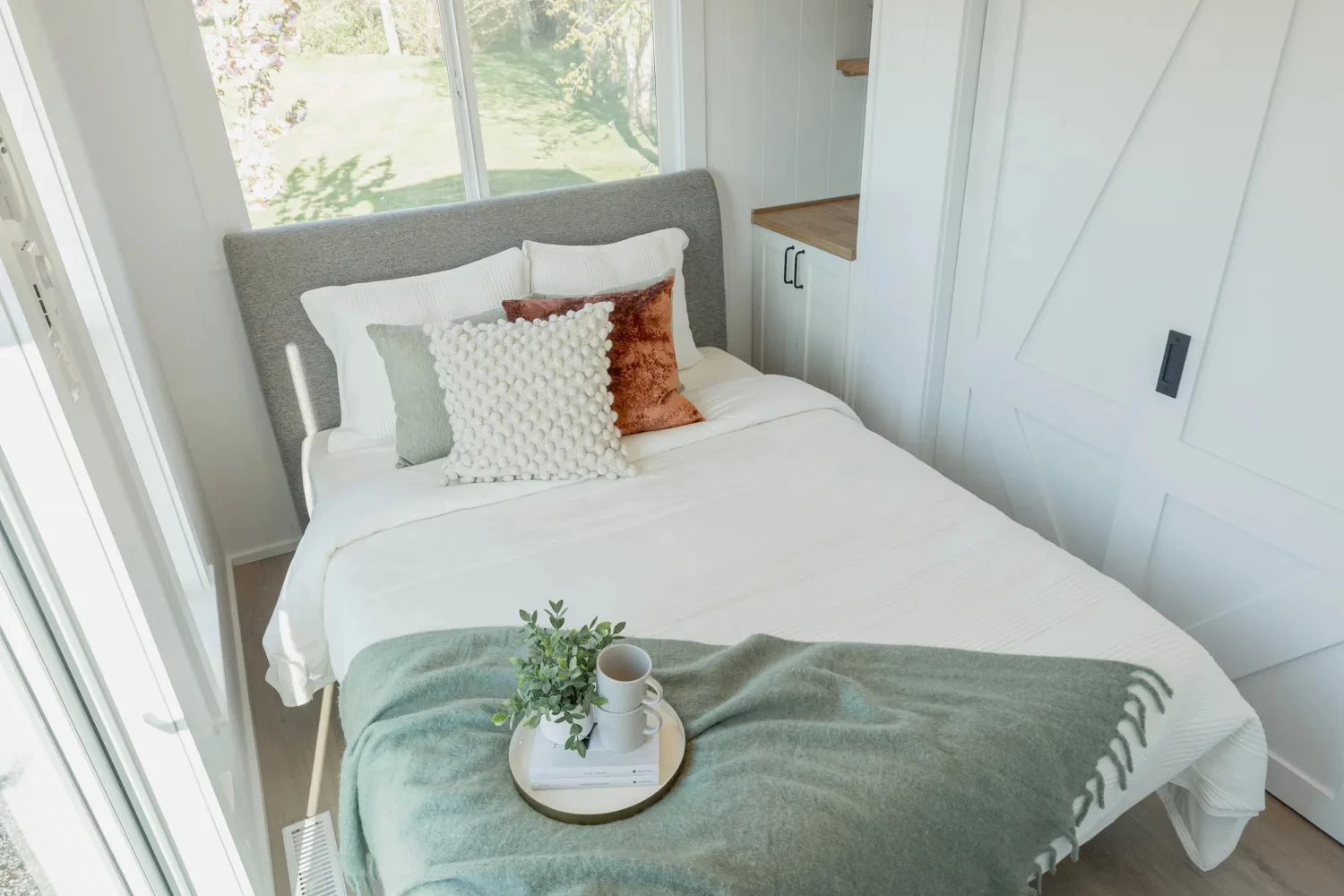The Ventura Park Model Tiny Home's master bedroom is downstairs and has ample headroom to stand upright