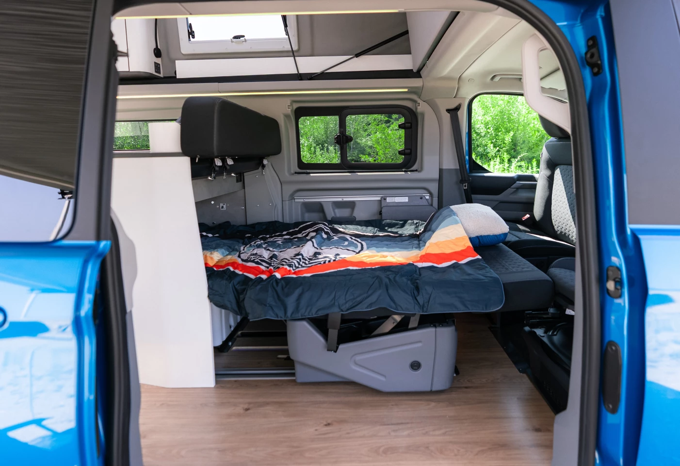 We've always liked the Nugget's three-room layout, but the front bed does not look like the most comfortable in the small camper van world