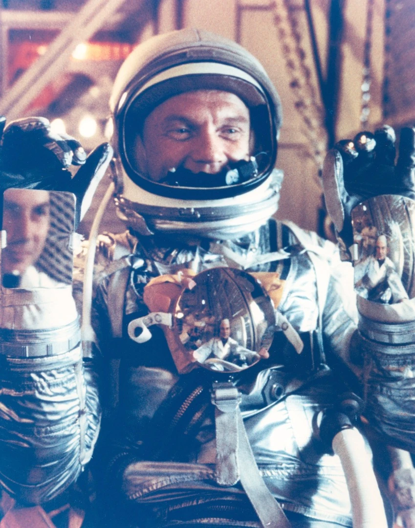 John Glenn showing off mirrors he used for reading instruments in the cramped space capsule