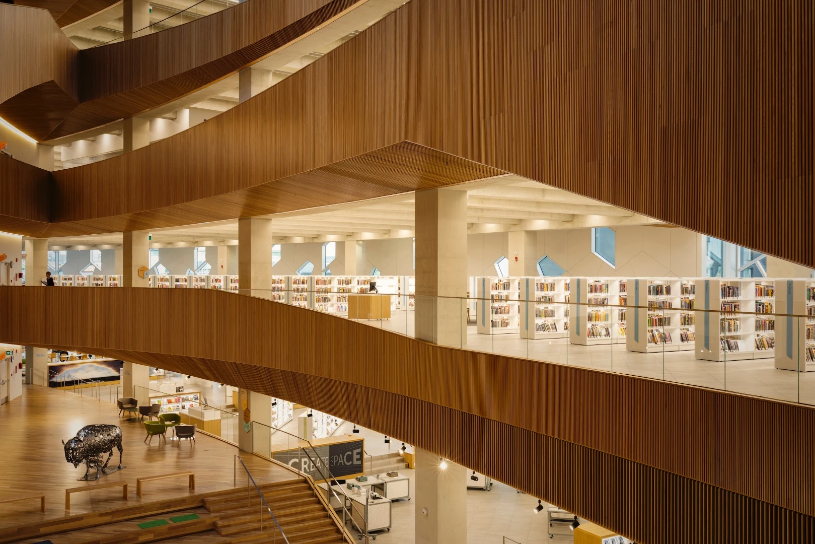 Calgary Central Library's interior is arranged so that louder public activities are carried out on the lower floors and quieter study areas are away from the noise on the upper levels