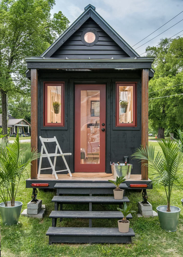 The tiny house is sure to turn heads with its distinctive stained ebony cedar board and batten siding