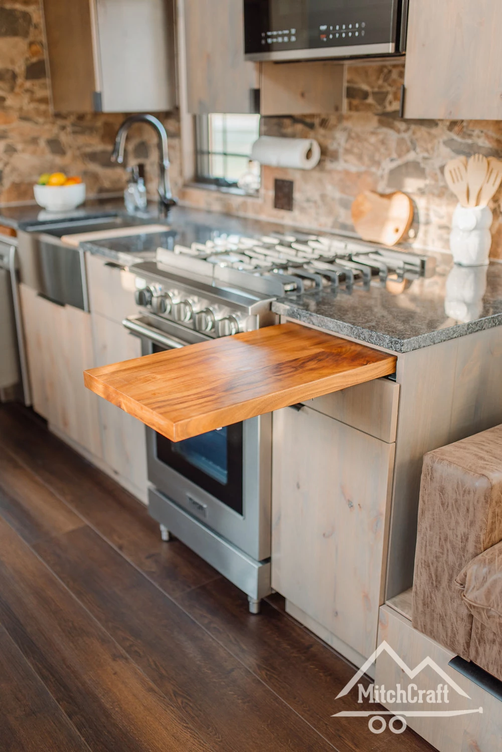 The kitchen in Lisa's 30 x 10 Tiny Home includes a handy pull-out cutting board