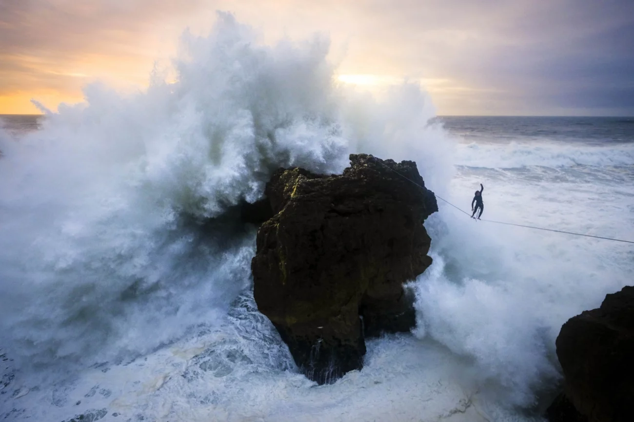 Awarded 3rd Place in Sports in Action. The Russian surfer Andrey Karr balances on a 2.5 cm wide piece of webbing in Nazare, Portugal