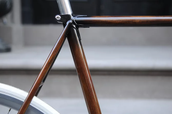 New Zealand's Rob Pollock hand-paints clients' bicycle frames with a faux woodgrain finish