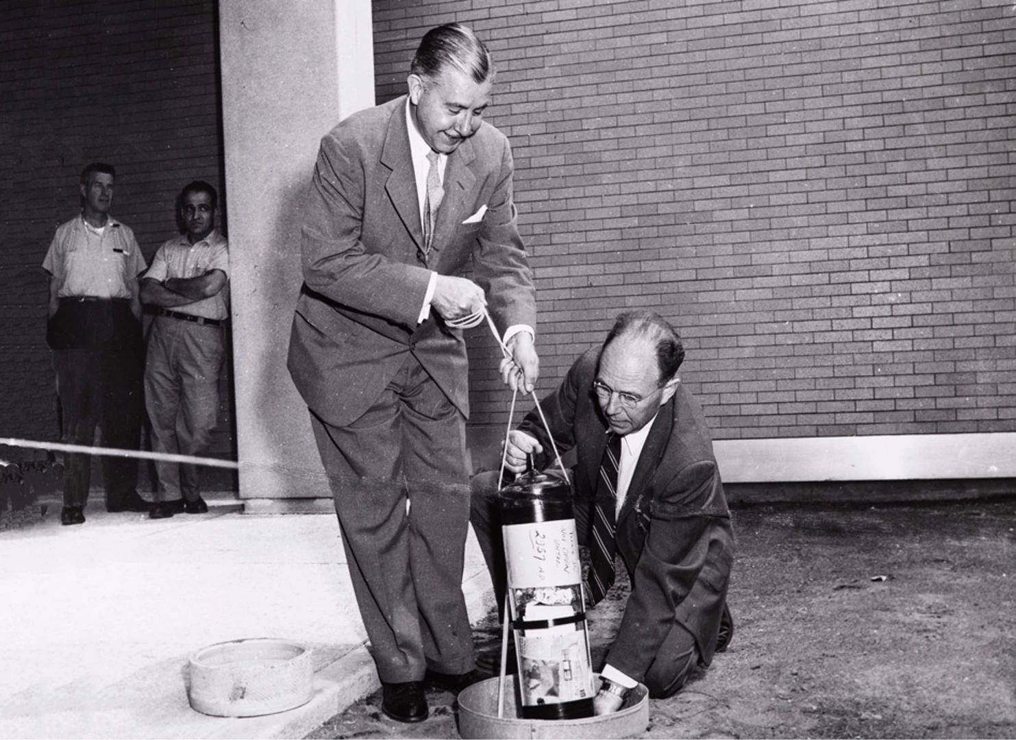 Killian Jr. (left) and Edgerton burying the time capsule