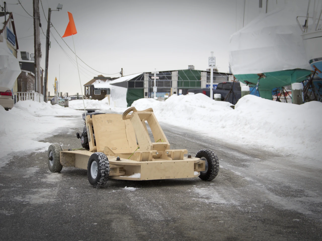 The kart features rack and pinion steering, an adjustable seat, a smartphone mount for capturing action video footage, and disc brake system
