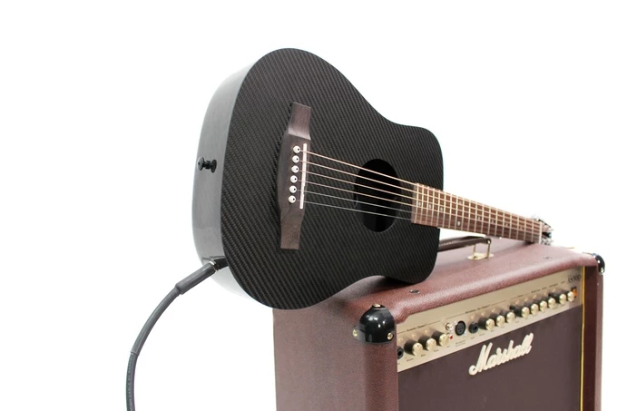The Sonitone system in the Klos acoustic/electric travel guitar includes a Sonicare pickup, onboard tone and volume controls, and a 9 V battery box