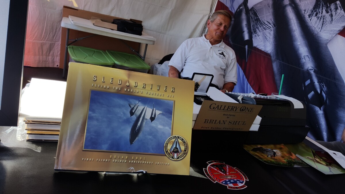 SR-71 Blackbird pilot Brian Shul with his book, Sled Driver