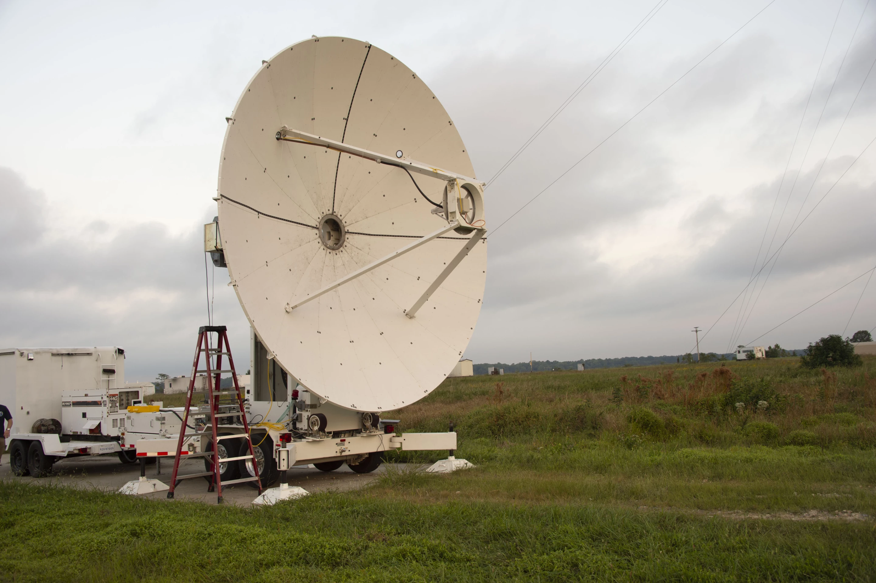 A microwave dish transmitter is pointed toward a rectifying antenna in part of the Safe and Continuous Power Beaming – Microwave (SCOPE-M) demonstration