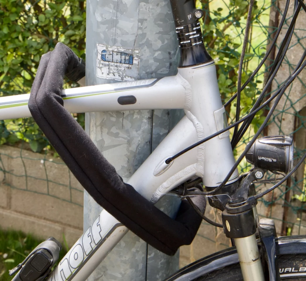 Once it's time to leave the bike unattended, the Nexibi is removed from the bracket, wound around the bike's frame and an adjacent immovable object, and its two ends are then locked together with a key