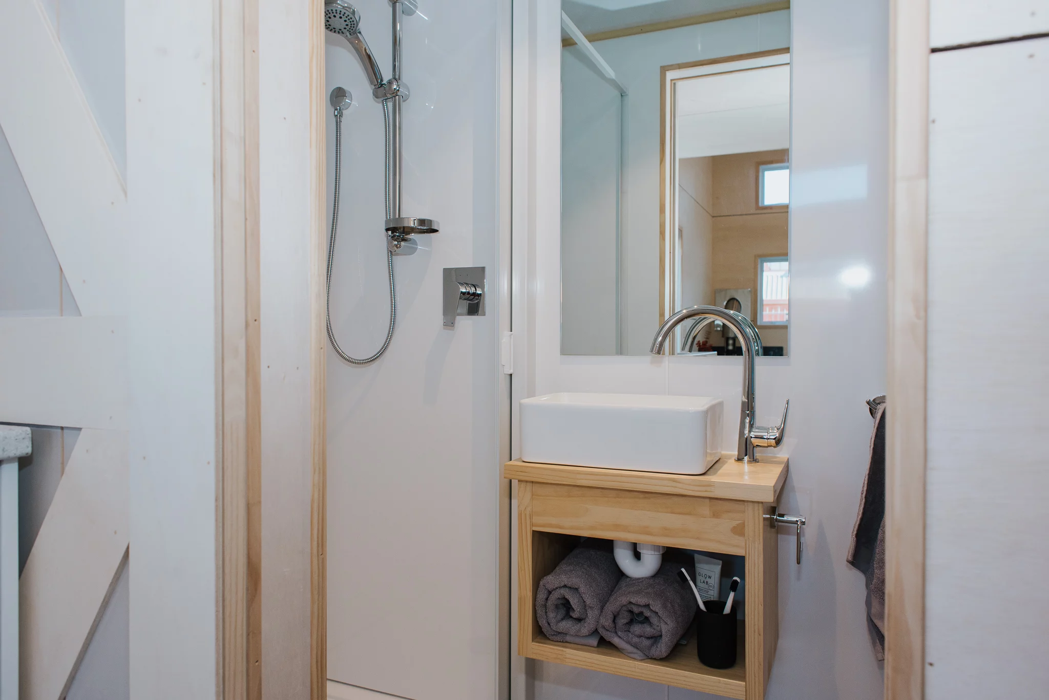 The Purple Palace's bathroom includes a shower, sink, and toilet