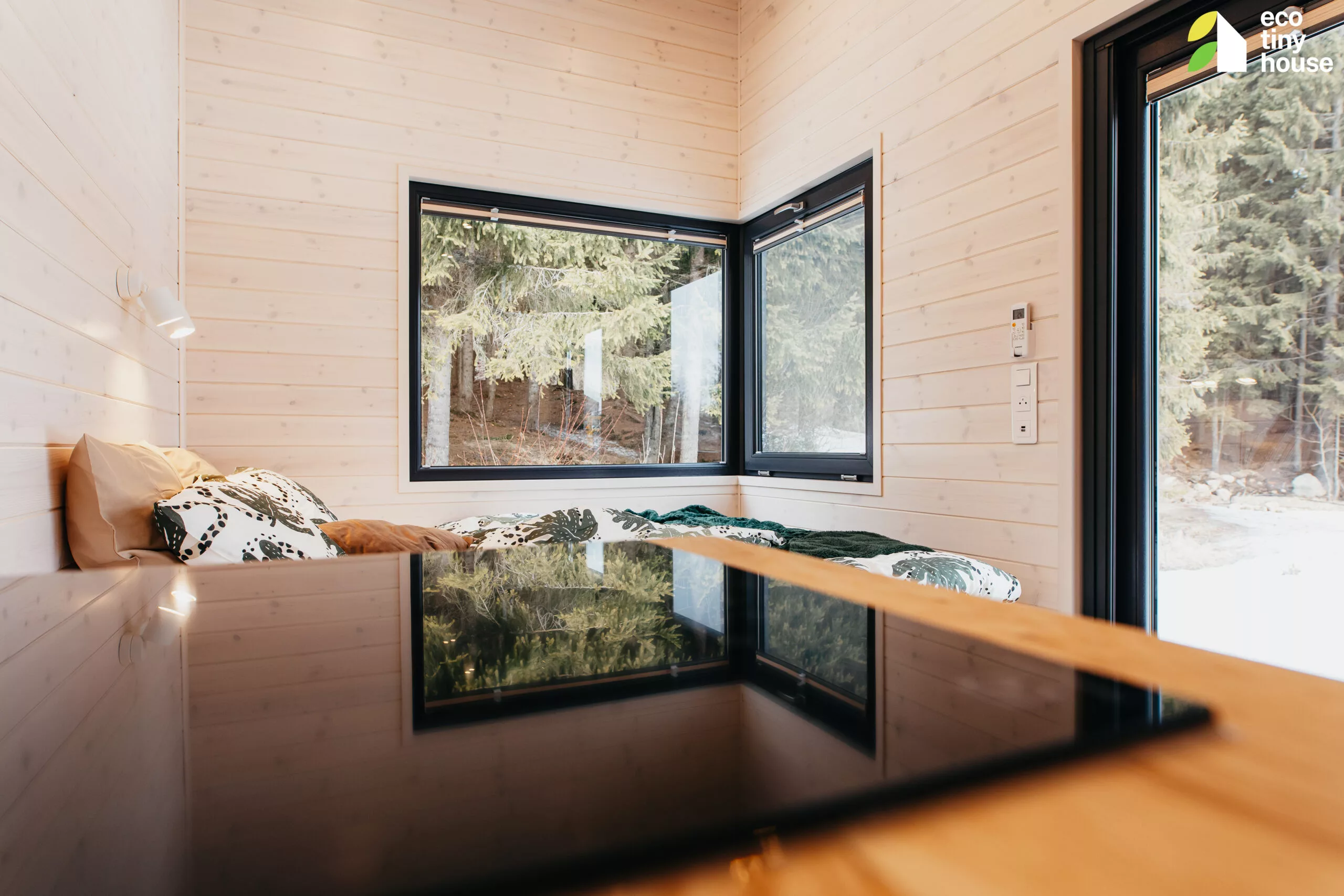 The Tiny Rubik's kitchen includes a sink, an induction cooktop, and both lower and upper cabinetry