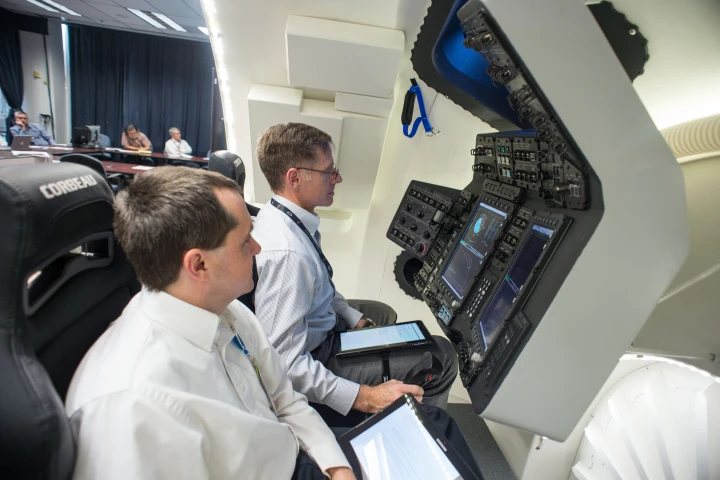 Chris Ferguson (center) at the simulator controls