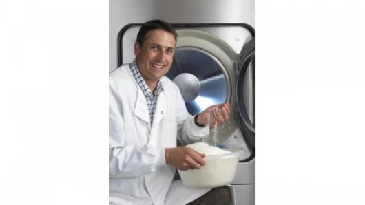 Nathan Wrench, program manager at Cambridge Consultants, and the nylon beads used in the Xeros washing machine (Photo: Xeros)