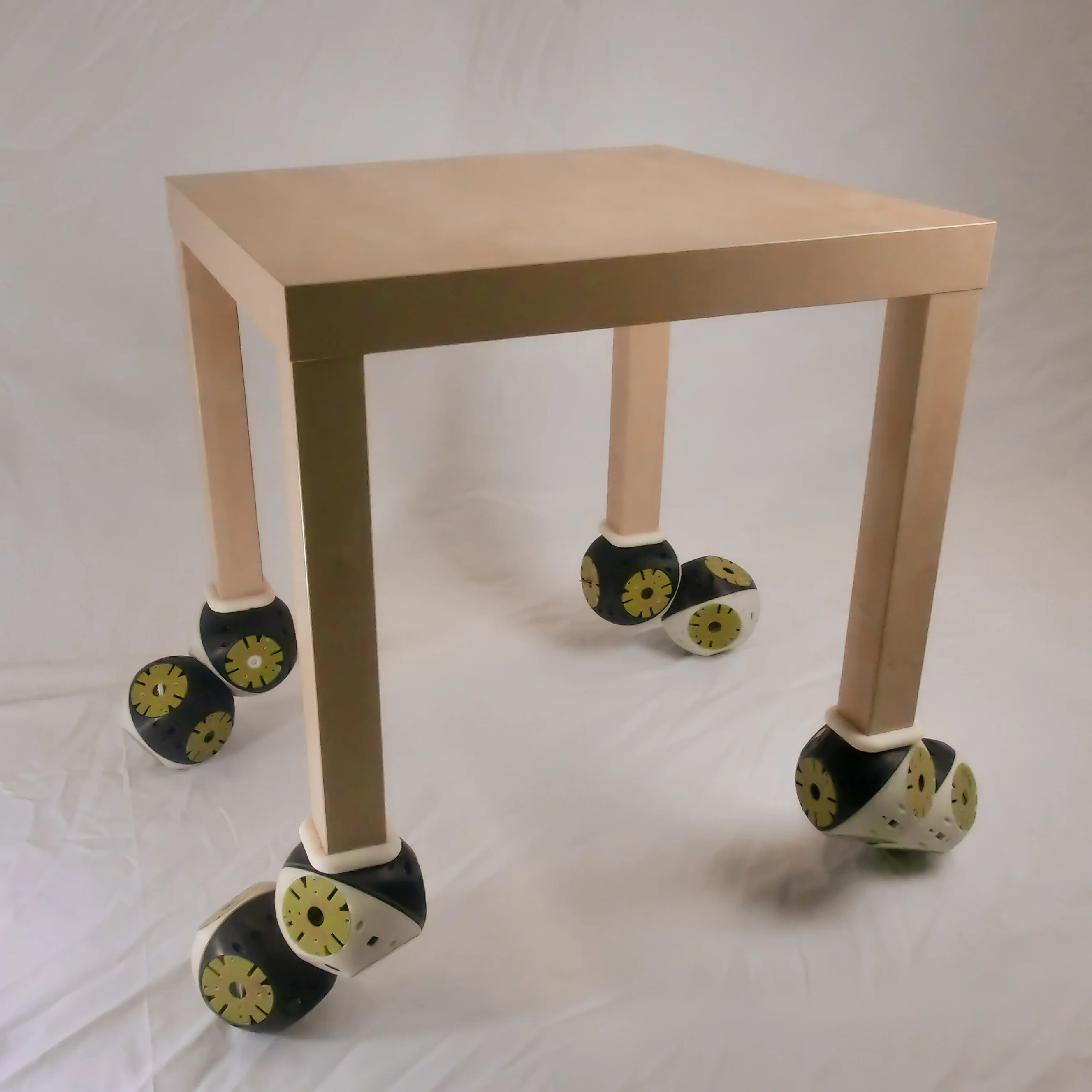Roombots attach to a table enabling it to move (Photo: Biorobotics Laboratory, EPFL)