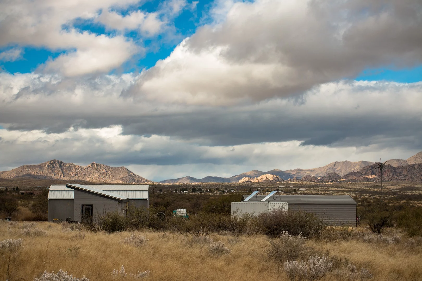 As I approached the tiny home compound, I could see the layout better. The solar panels and the wind turbine were the first thing to catch my eye.
