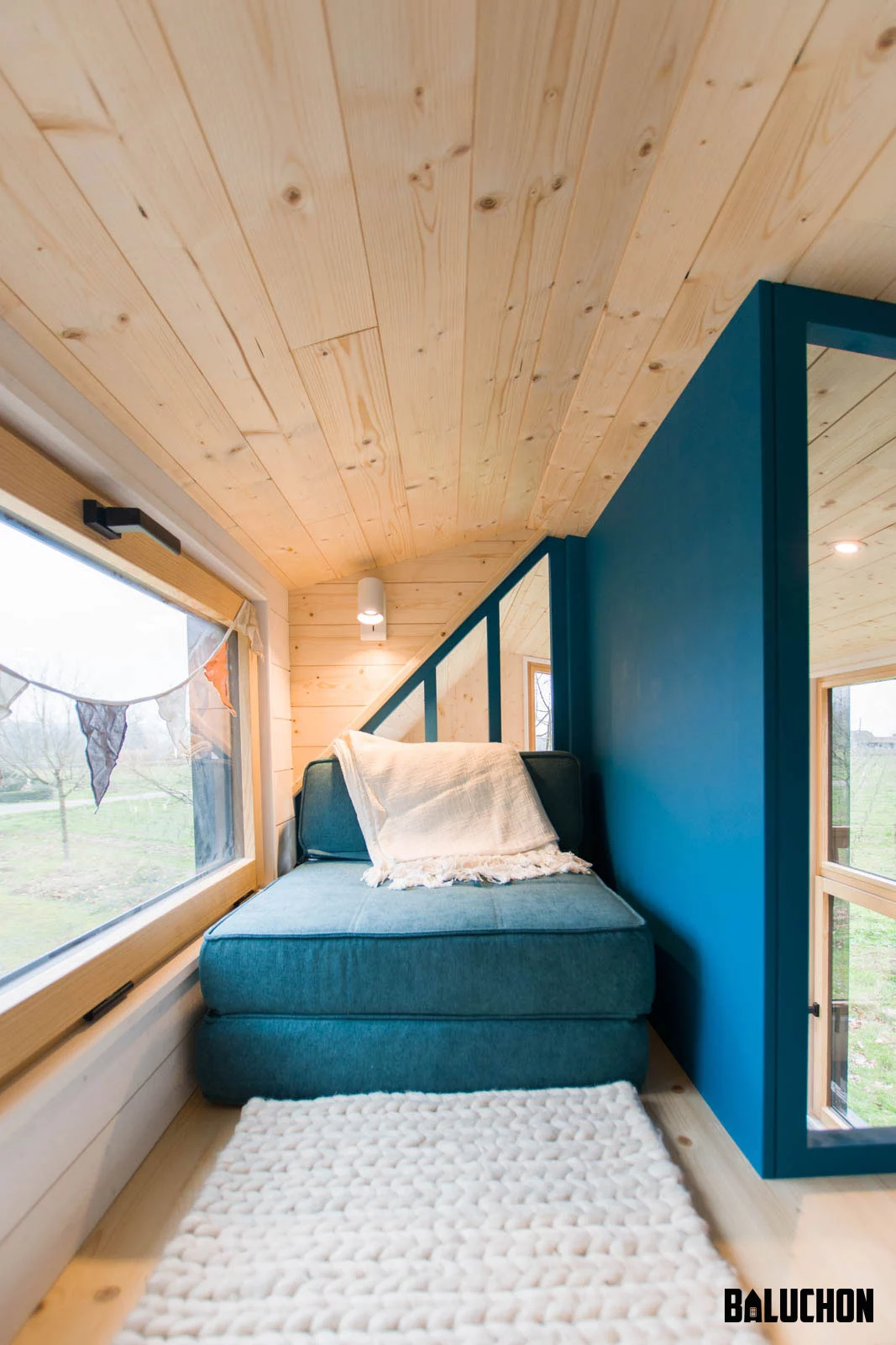 The Kejadenn's secondary bedroom is also situated in the upstairs loft and includes some seating that folds out to serve as a bed for the owner's child