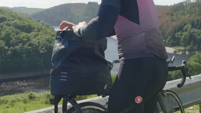 Opening the Tailfin AeroPack's wide-mouth roll-top bag
